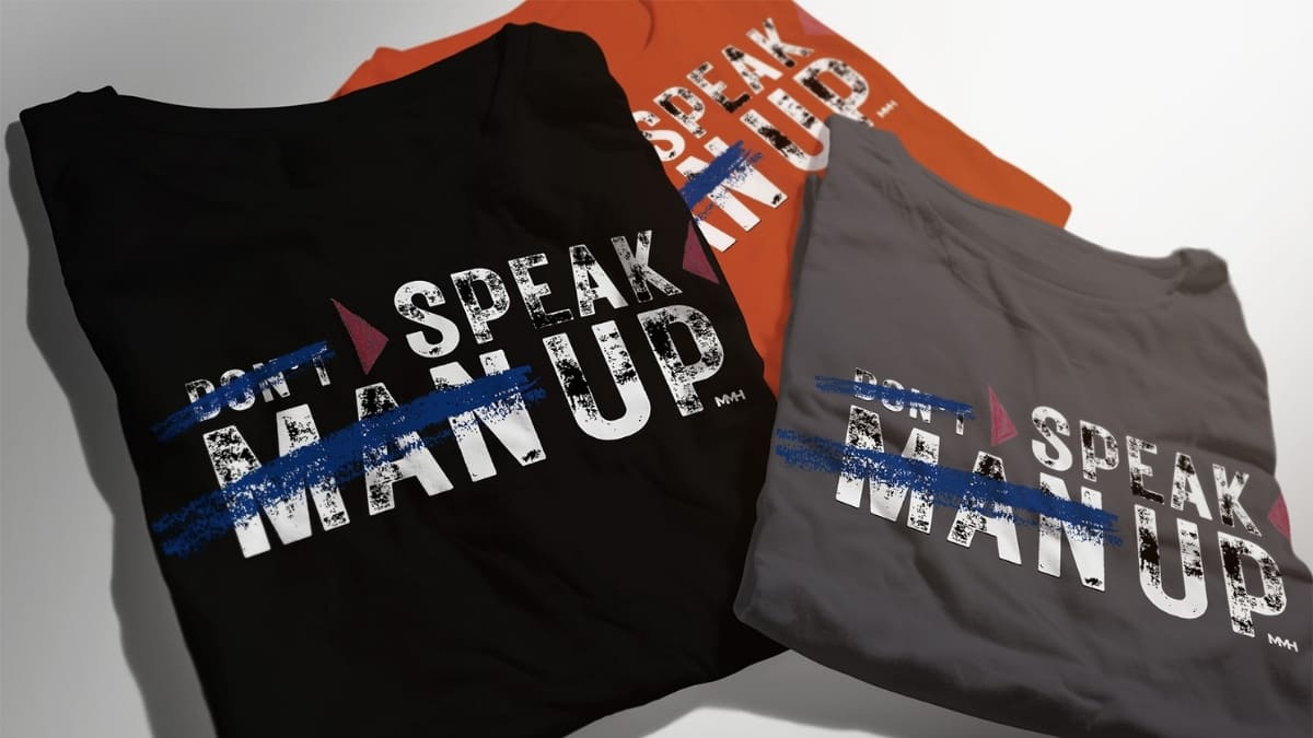 MMH Merch don't Man Up Speak Up Tshirts Three MMH Clothing T-shirts with the slogan “Don’t Man Up, Speak Up” printed on the front in different colours.