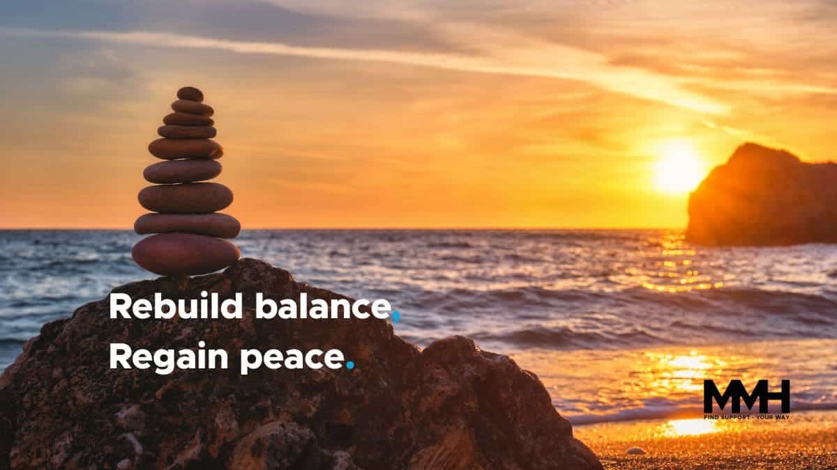 A stack of balanced stones on a rock by the ocean at sunset, with the text "Rebuild balance. Regain peace."