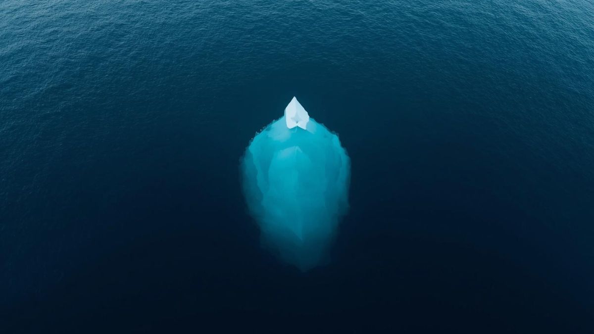 An iceberg showing a small tip above water and a large mass below, representing hidden emotions under anger.