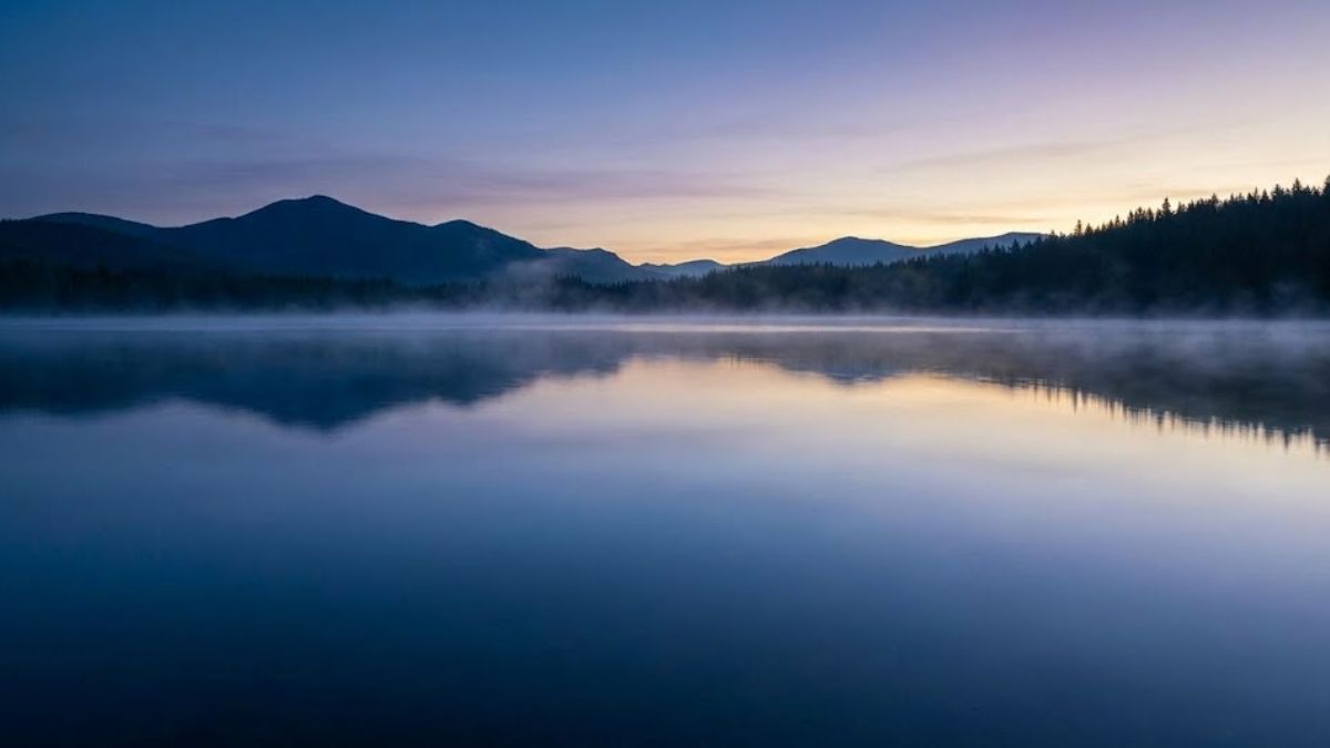 A still, cold lake with mist symbolizing the mental clarity achieved after cold therapy.
