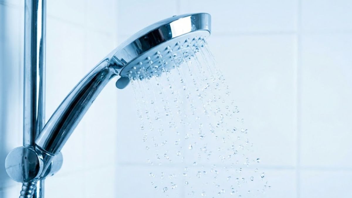 Close up of water falling from a shower head representing cold therapy start.