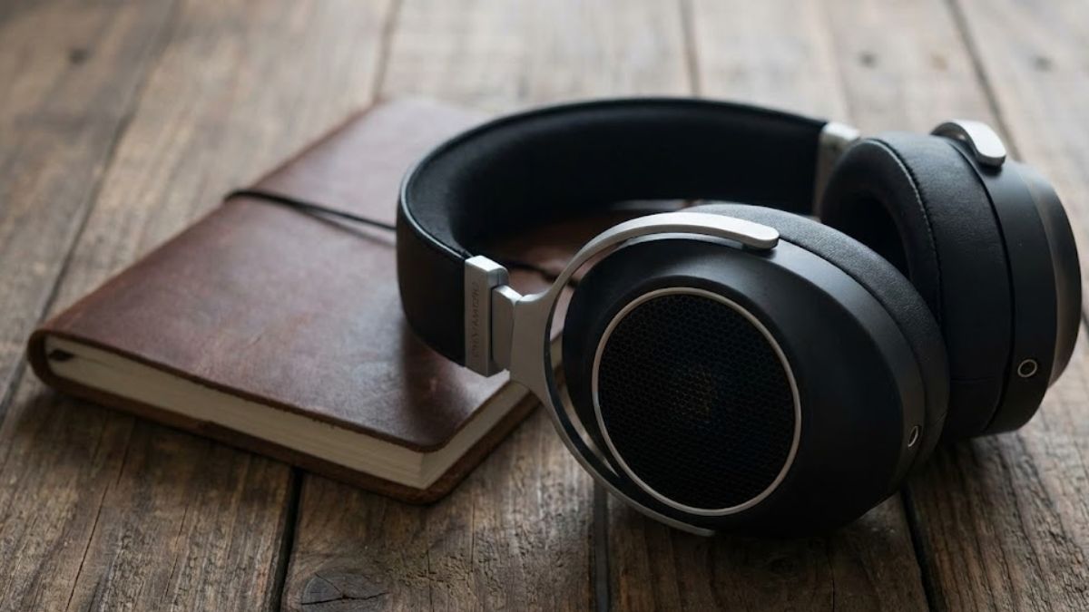 Headphones and a notebook on a desk representing music therapy.