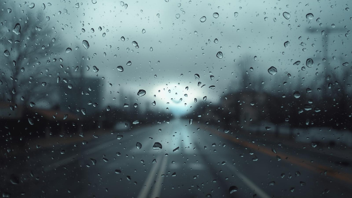 Looking through a rainy window at a clearing sky, symbolising the transition from isolation to clarity.