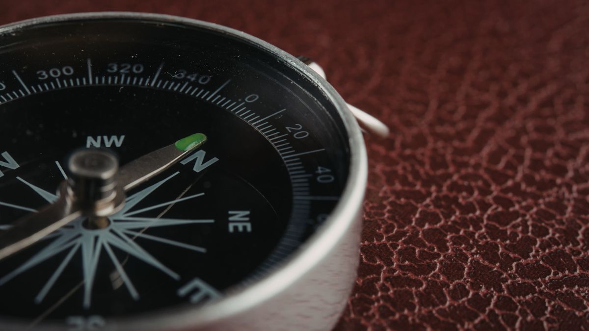A compass with a spinning needle representing the confusion of addiction.