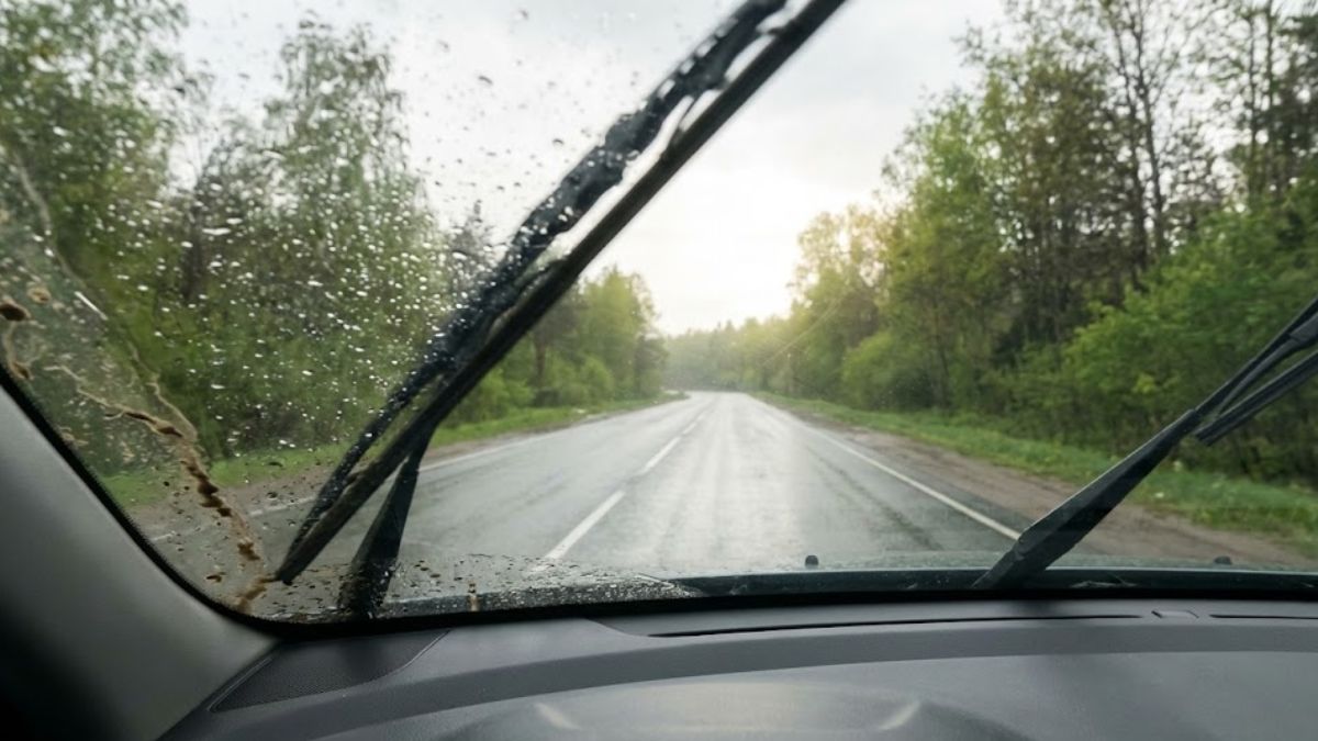 Car windshield wipers clearing rain to show the road ahead, symbolizing clarity of mind.