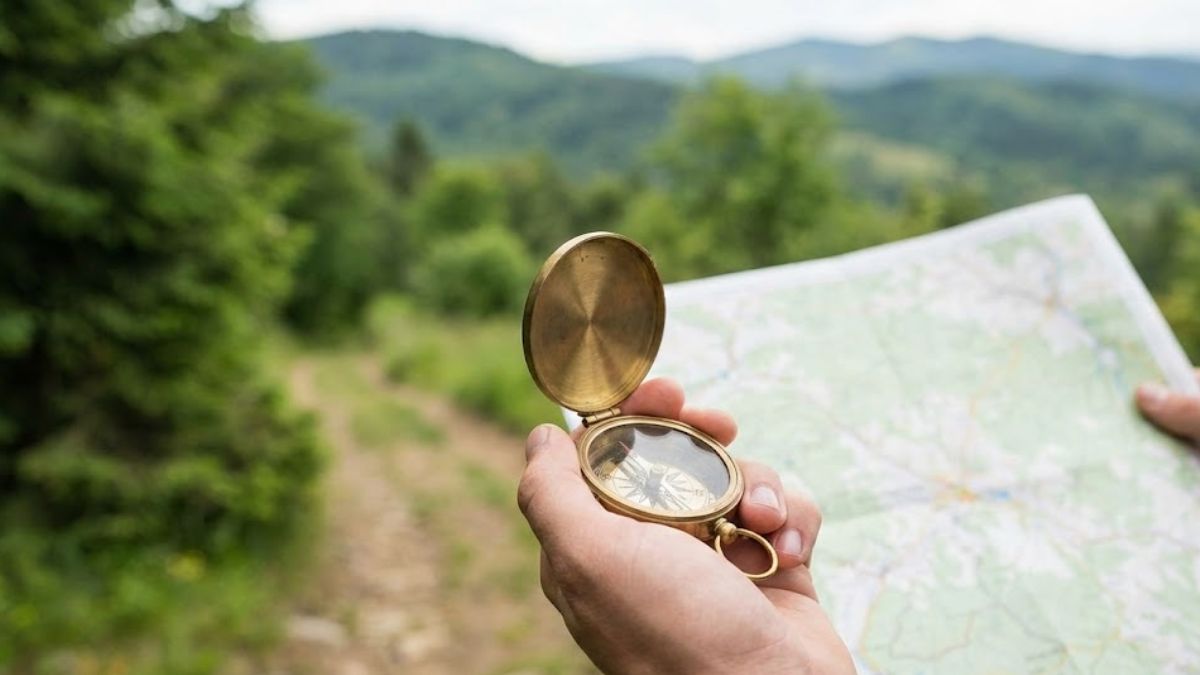 Hands holding a compass with a map, representing navigating the NHS and treatment pathways.