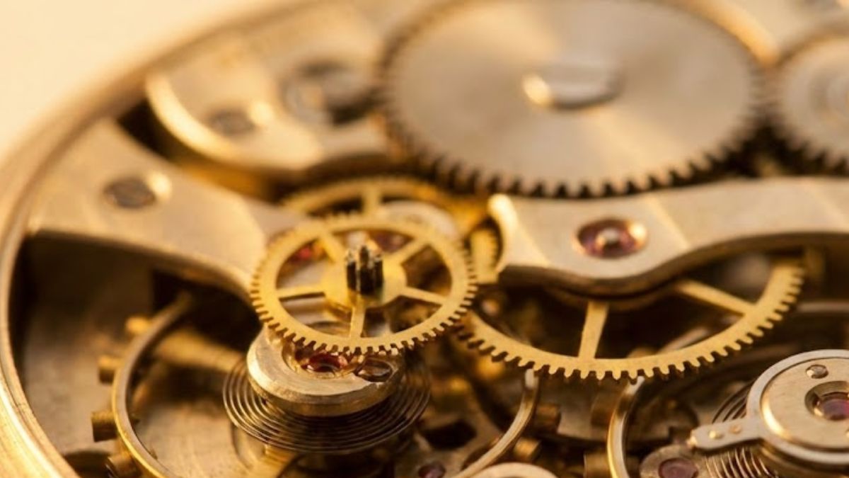 A close-up of a complex antique clock mechanism being repaired, symbolising the intricate workings of the mind.
