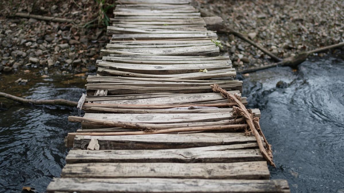 A wooden bridge with missing planks representing damaged trust.