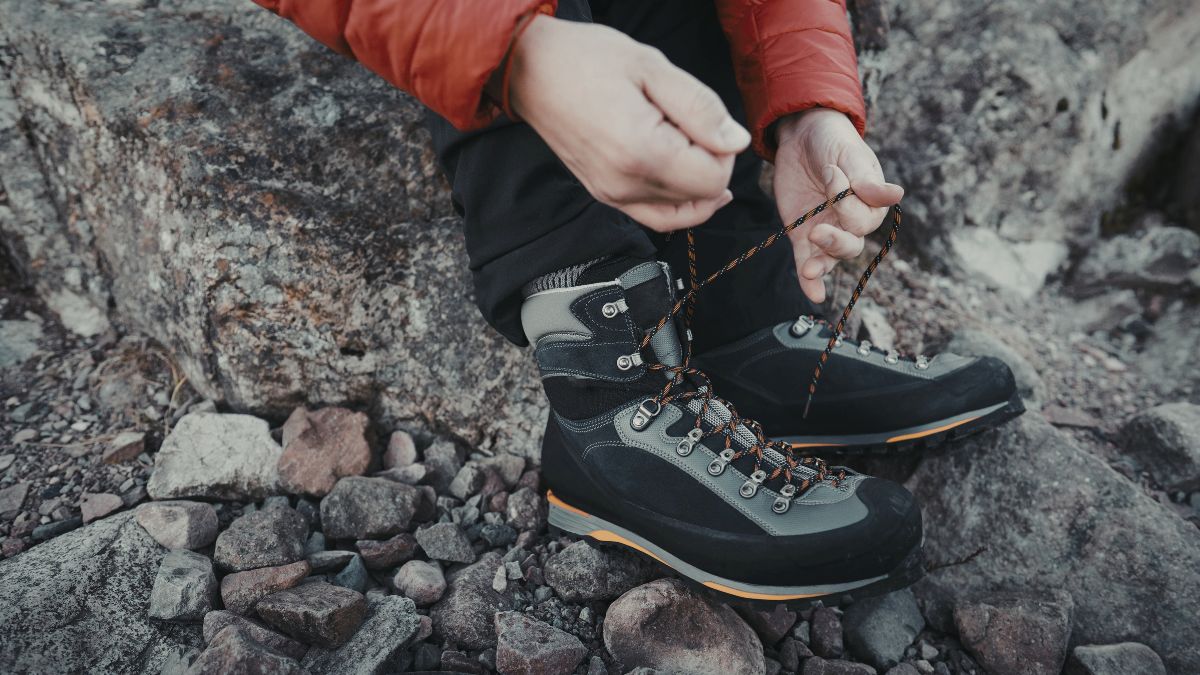A man tying his hiking boots, preparing to face the day.