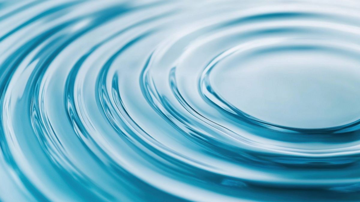 Ripples spreading in water, illustrating the ripple effect of loneliness on health.