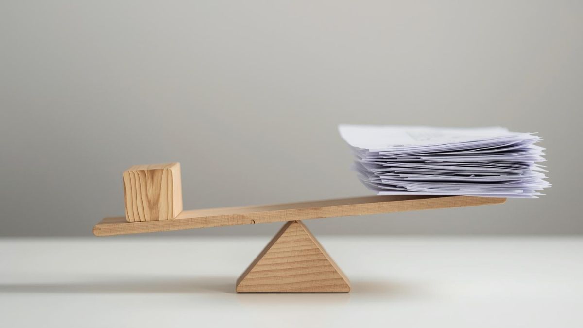 A balance scale weighing a toy against paperwork, symbolizing the pressure on fathers to provide and parent.